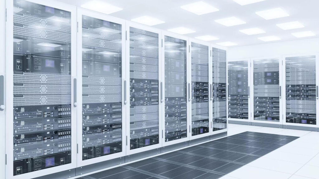 Bright white data-center room with rows of glass-door server racks on a raised, vented floor under evenly spaced ceiling lights.