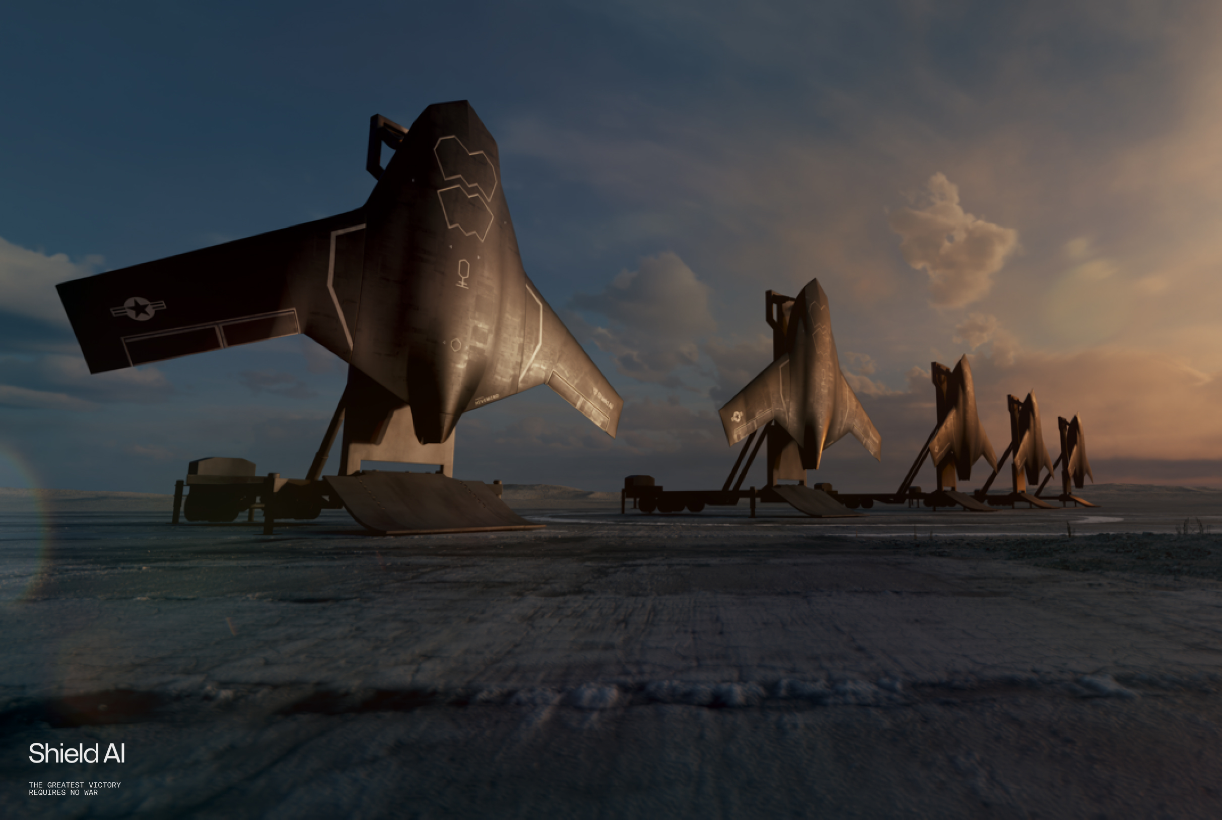 Line of Shield AI X-Bat VTOL aircraft mounted on mobile launch platforms, positioned in a desert at sunrise.