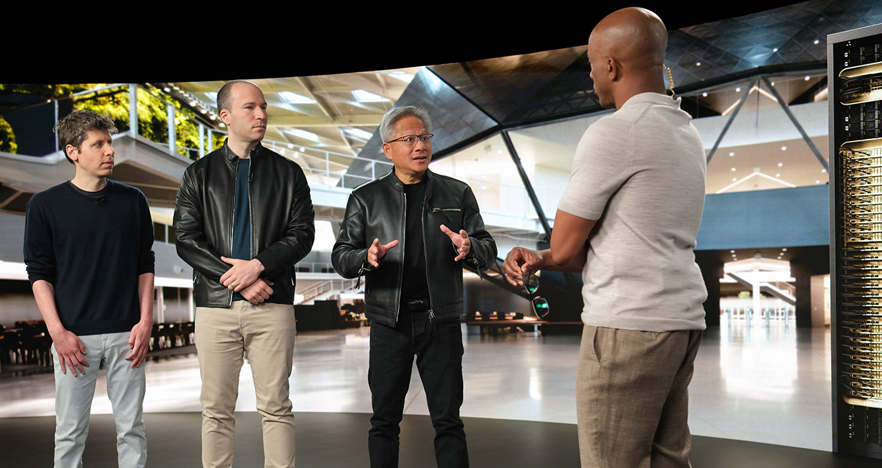 Four technology executives in conversation in a modern corporate setting discussing AI and computing innovation.