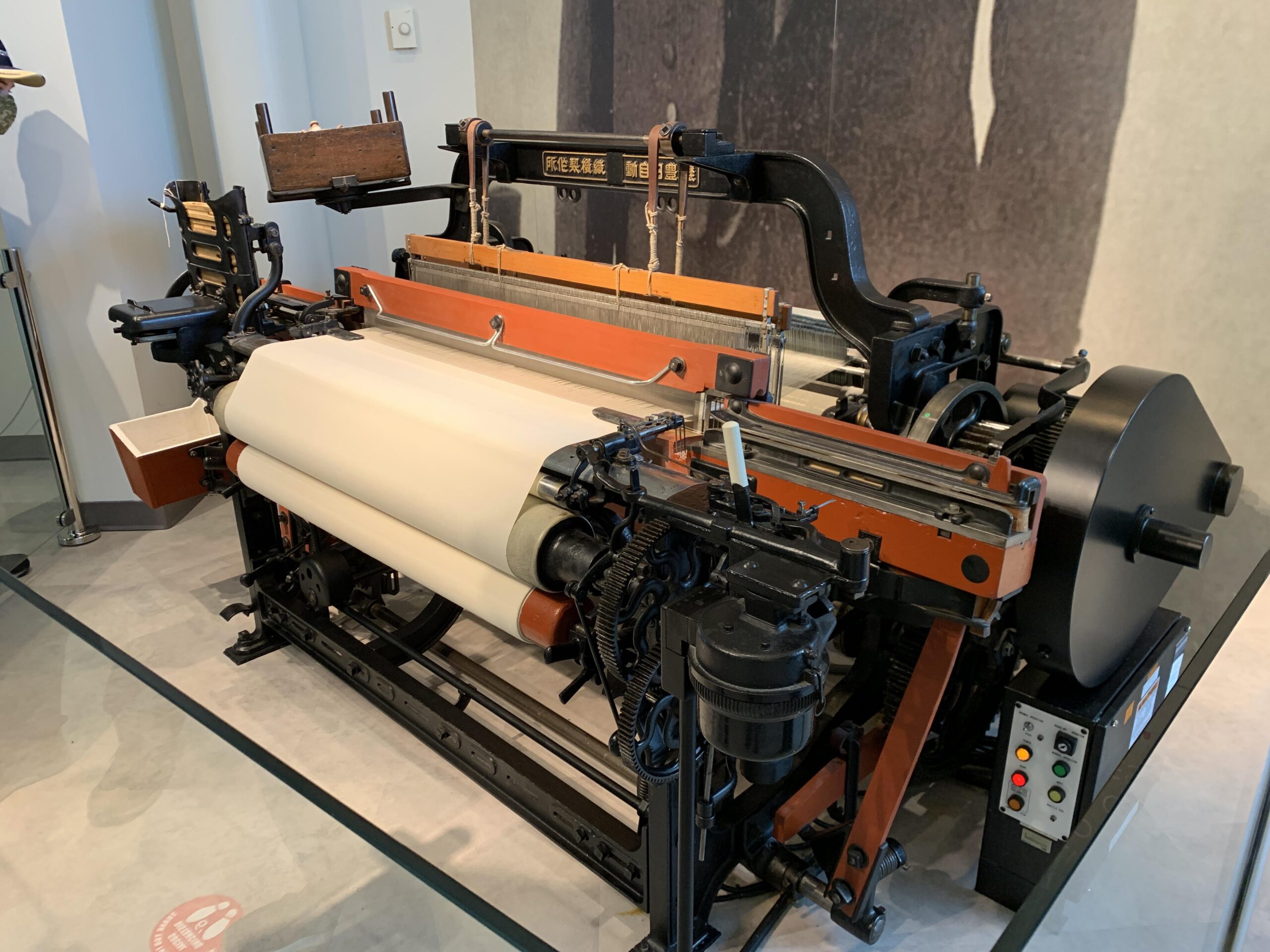 Toyoda Type G Automatic Loom The Origin of Toyota – Tumisang Bogwasi Toyoda Type G Automatic Loom on display with threads and cloth roll in a museum exhibit